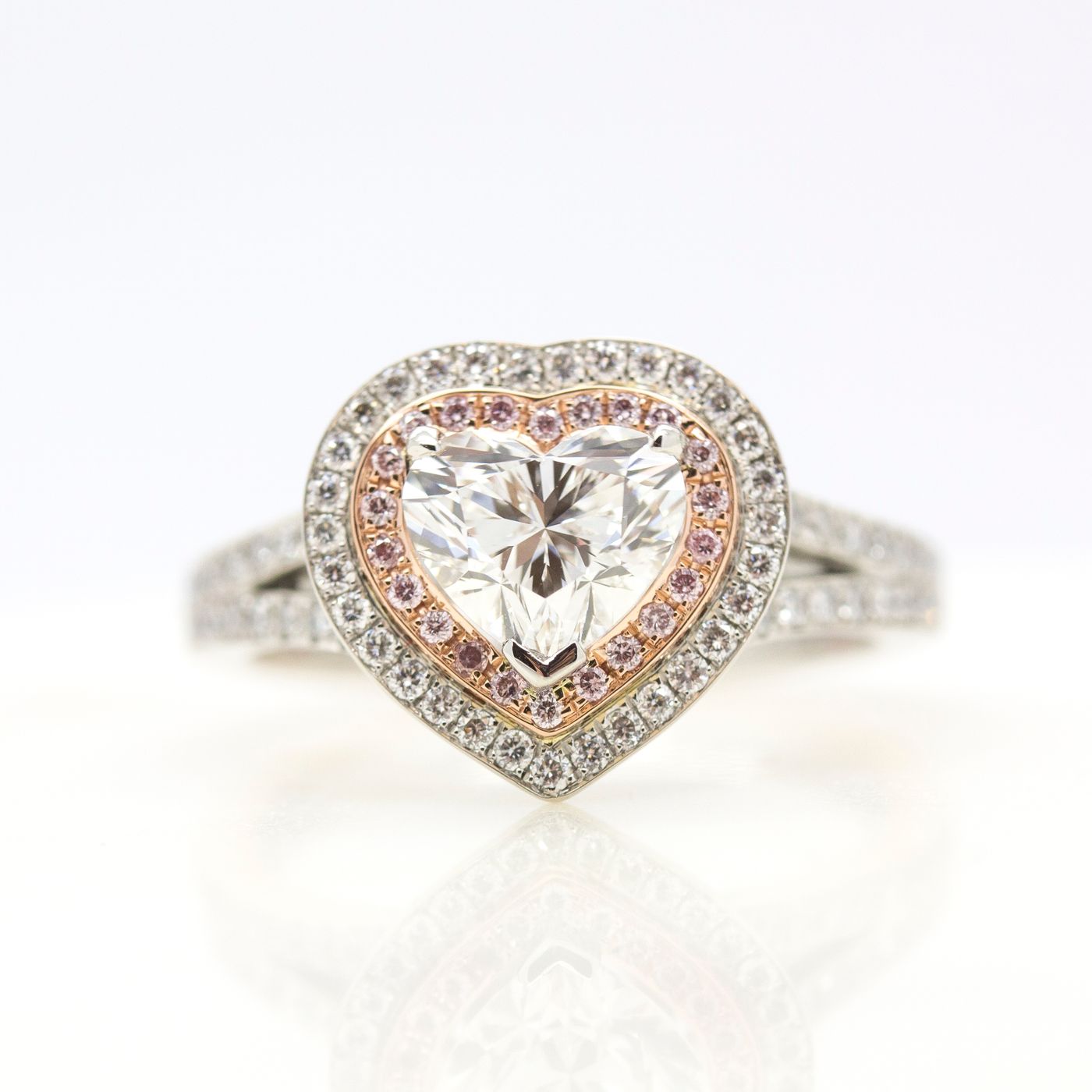 Heart shaped diamond pink and white diamond halo engagement ring