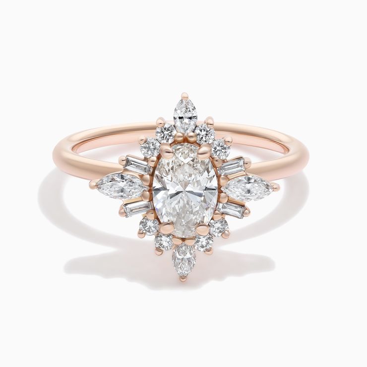 Oval diamond engagement ring with tapered baguette and round diamond fanned halo rose gold