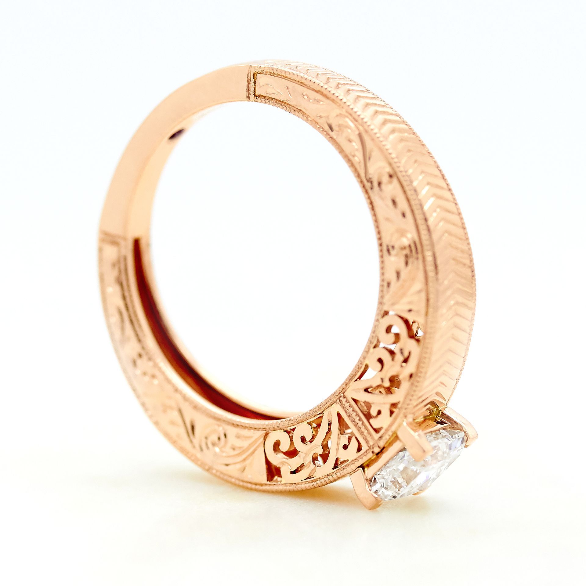 Rose gold engagement ring with filigree chevron hand engraving and delicate milgrain