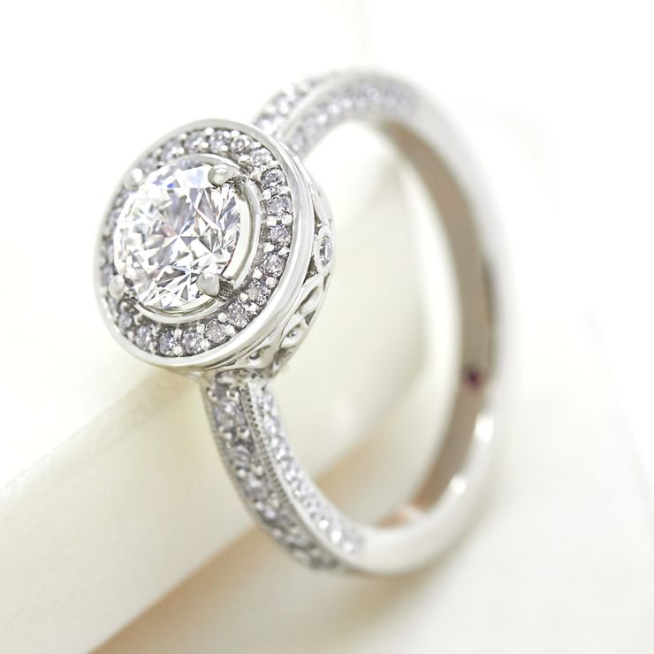 Round diamond halo engagement ring with filigree undergallery collet