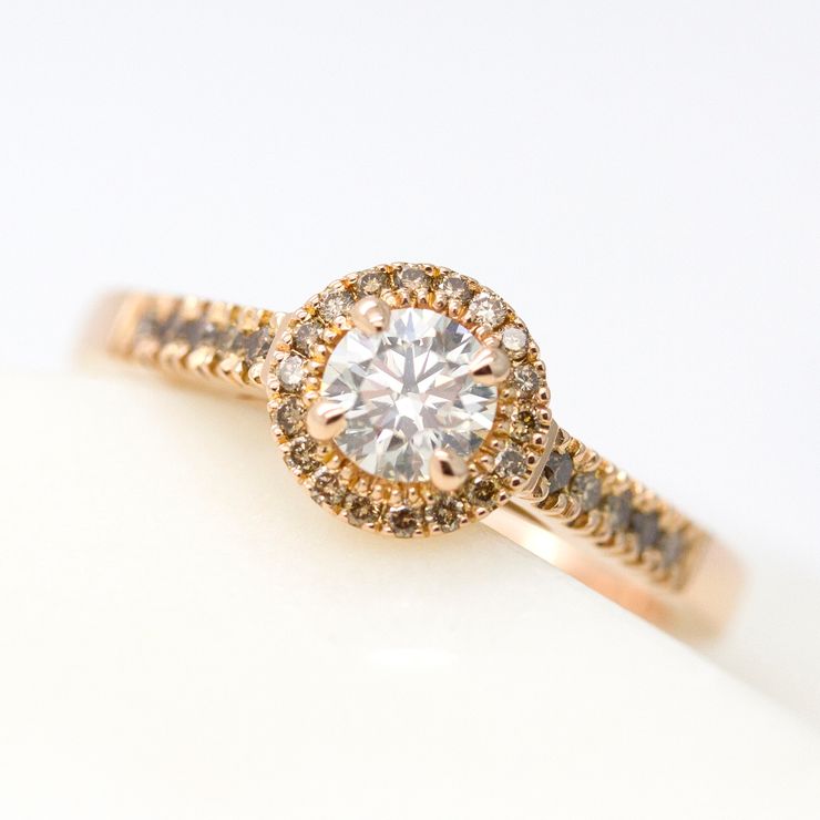 Round diamond with- cognac diamond halo and pave band set in rose gold