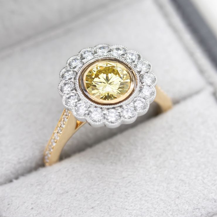 Round yellow diamond with floral inspired diamond halo in yellow gold and platinum