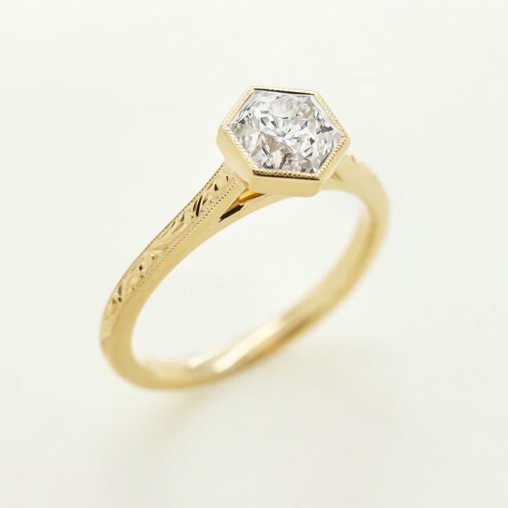 Hexagonal diamond engraved with milgrain engagement ring