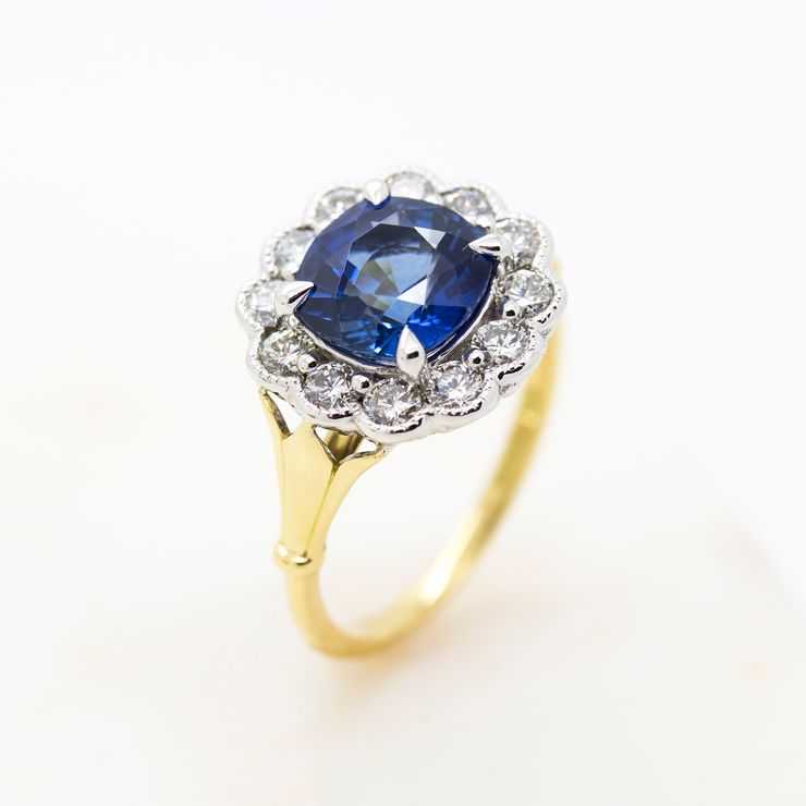Georgian inspired engagement ring with blue sapphire and rose cut diamond halo