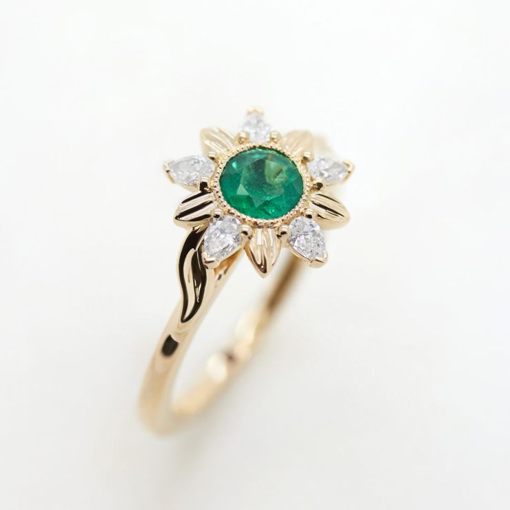 Round emerald yellow gold engagement ring