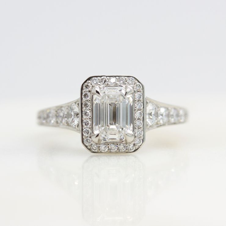 Emerald cut diamond engagement ring with tapering diamond bead-set band