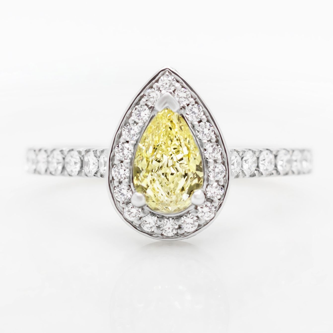 Fancy yellow pear shape diamond with diamond halo engagement ring