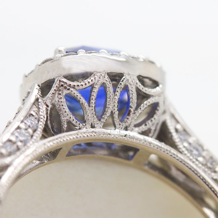 Blue sapphire engagement ring with milgrain collet detail