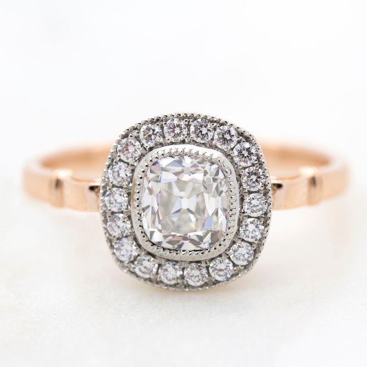 Old mine cut diamond with diamond halo in rose gold and platinum