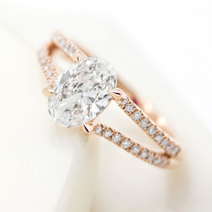 Oval diamond engagement ring with split shank rose gold pavé diamond band