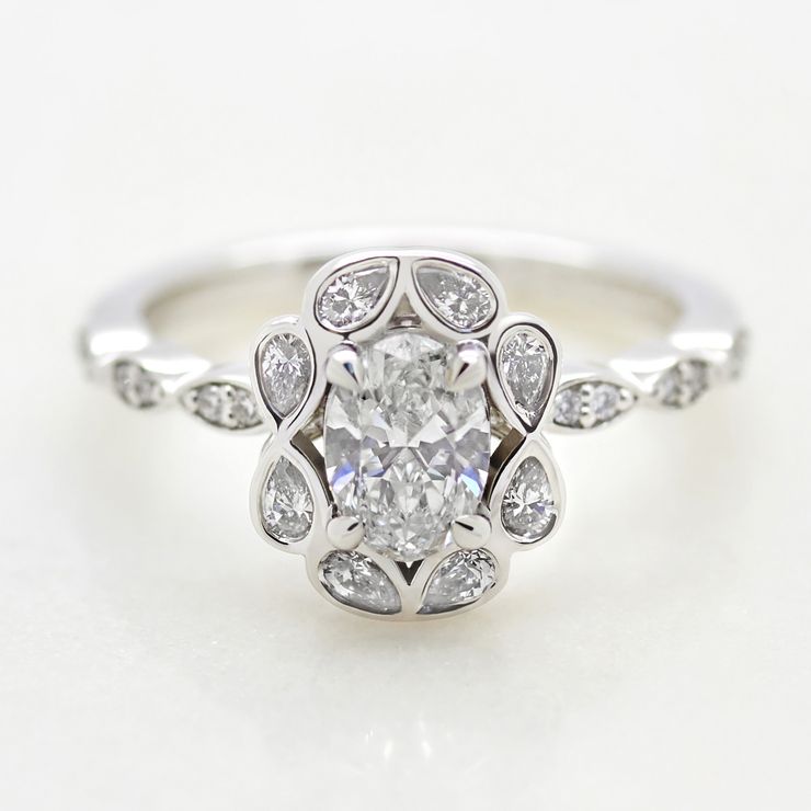 Oval diamond and a pear diamond halo engagement ring 