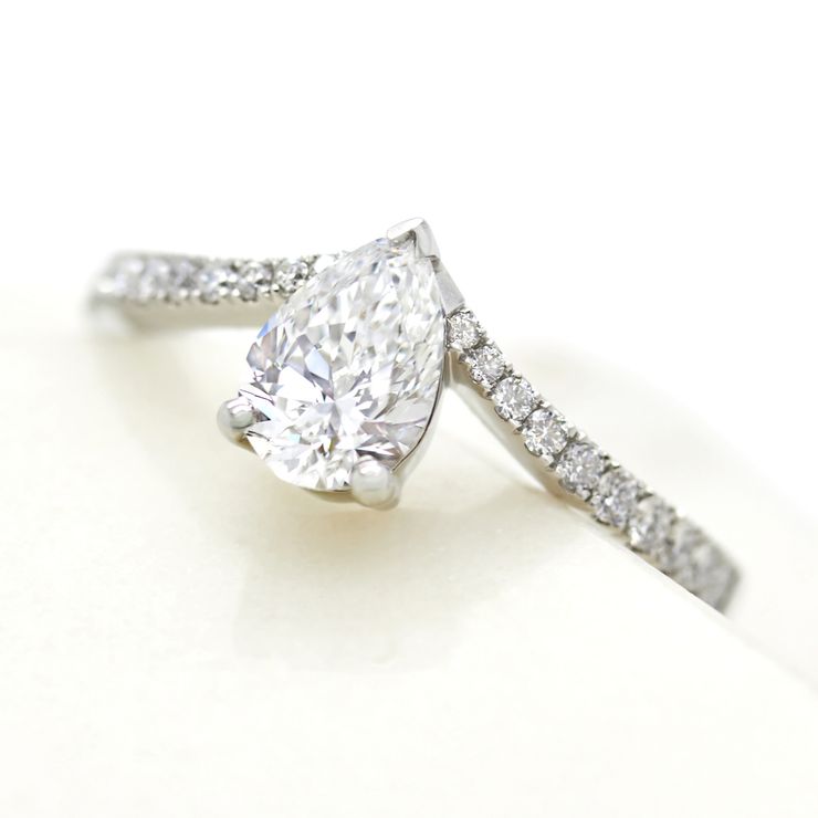 Pear diamond engagement ring with chevron pavé diamond band