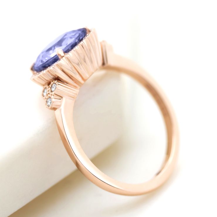 Portuguese cut purple sapphire with diamond halo, accent stones and milgrain