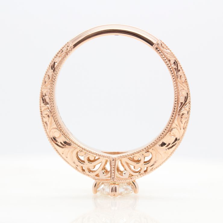 Rose gold engagement ring with filigree cut outs and milgrain