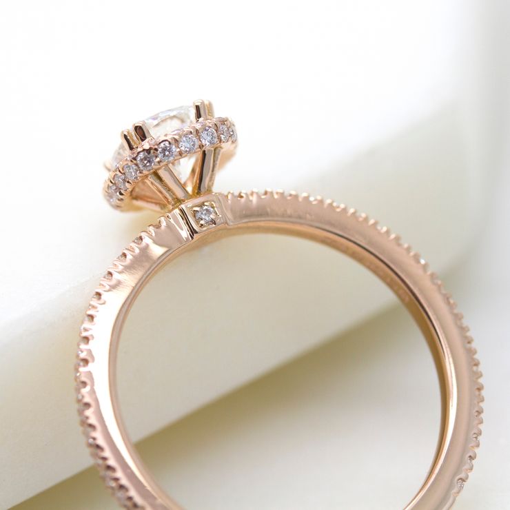 Rose gold engagement ring with pave collet detail and pavé set diamond on the bridge