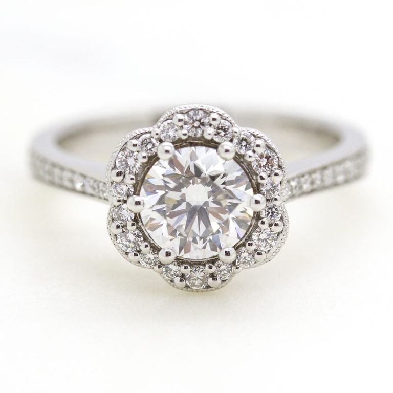Round diamond with flower inspired halo engagement ring