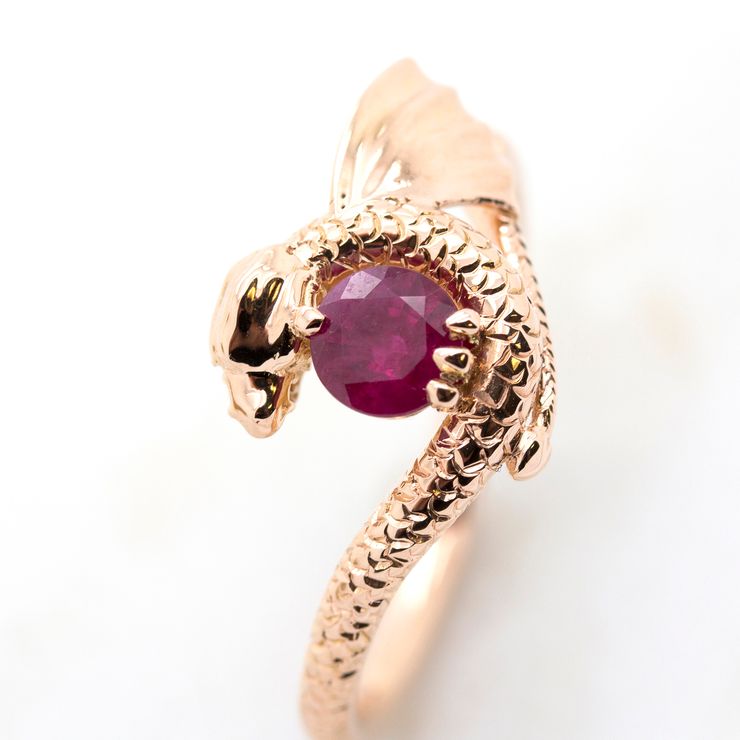 Round ruby centre with dragon inspired setting and hand engraving in rose gold