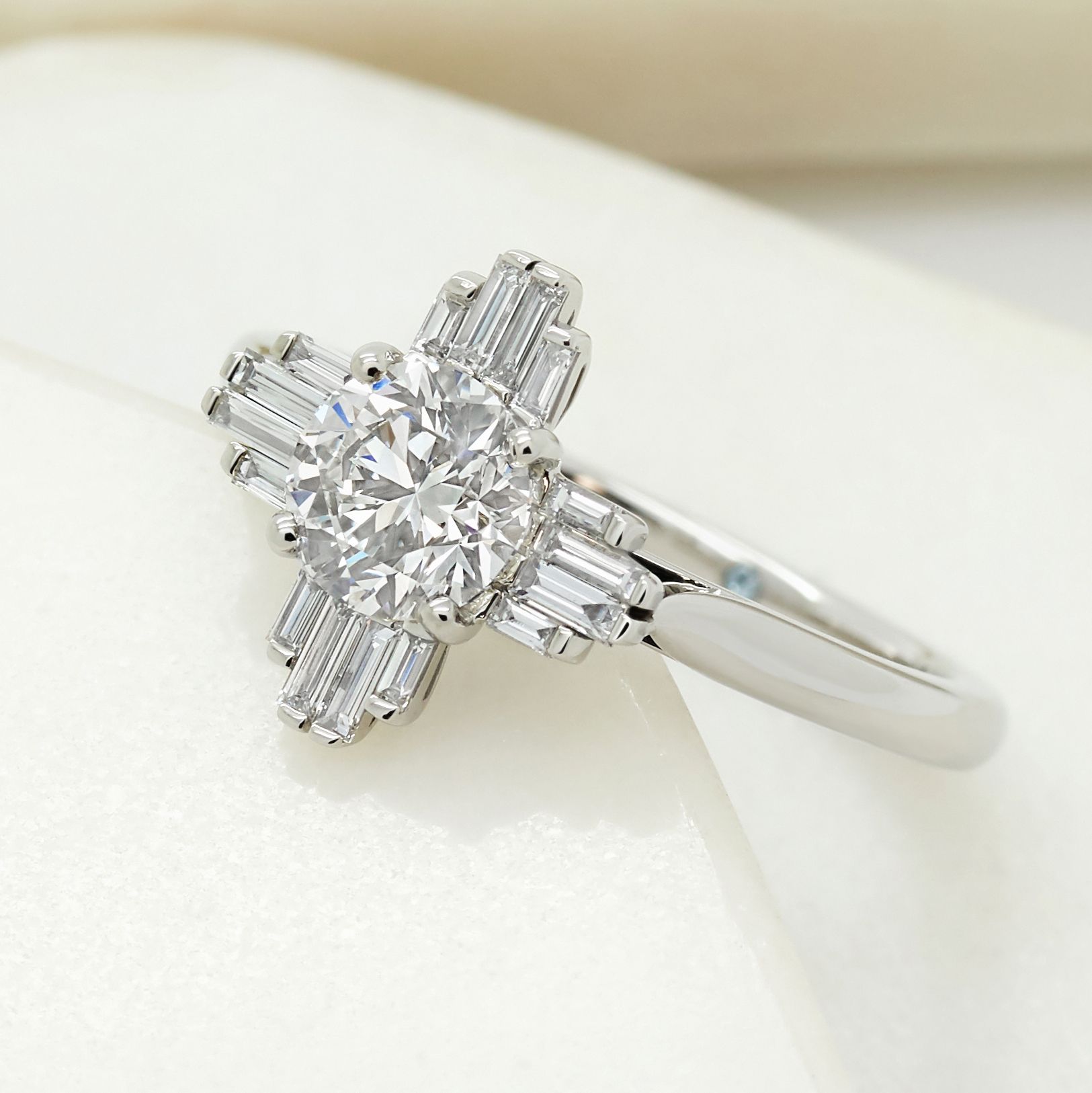 Art deco inspired round diamond with baguette diamond side accent stones