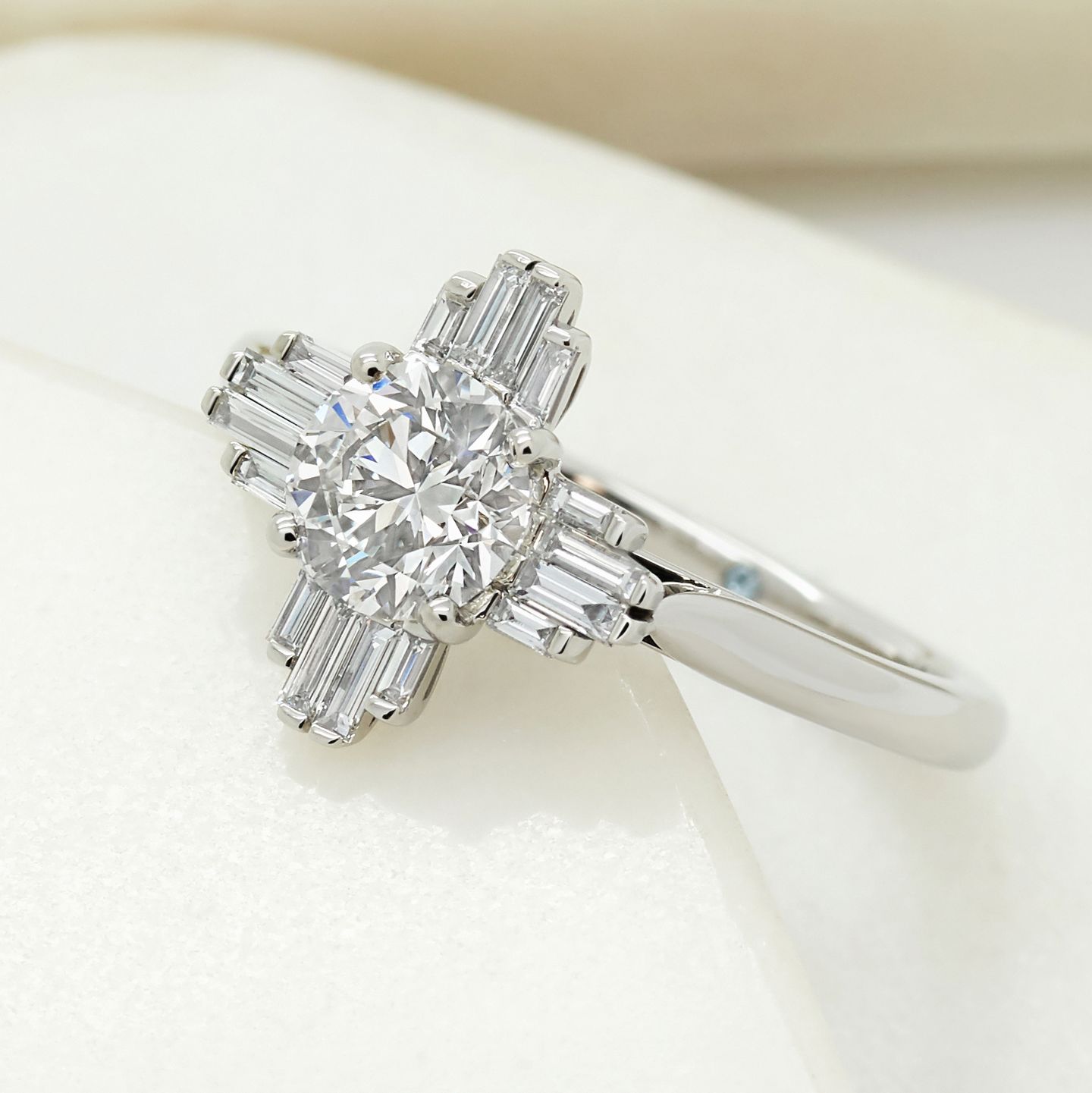 Art deco inspired round diamond with baguette diamond side accent stones
