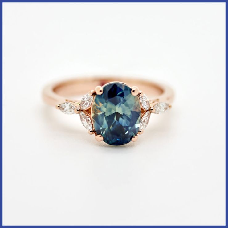 Teal oval sapphire floral engagement ring