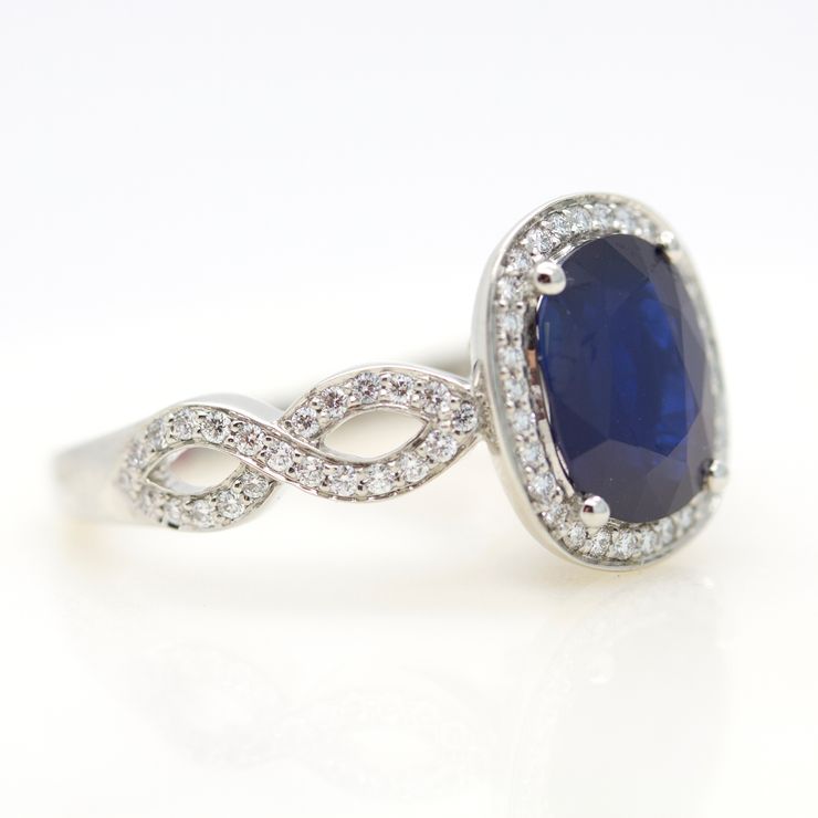 Twisted pavé band sapphire halo engagement ring