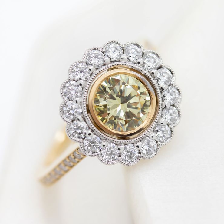 Yellow diamond and a round diamond halo with milgrain