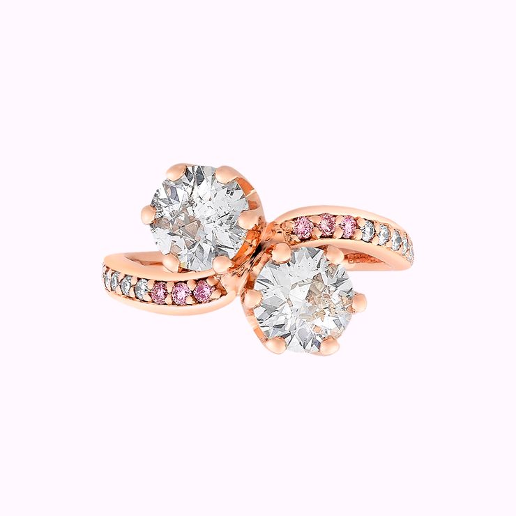 rose gold two-stone curved band with pink diamonds and two round white diamonds