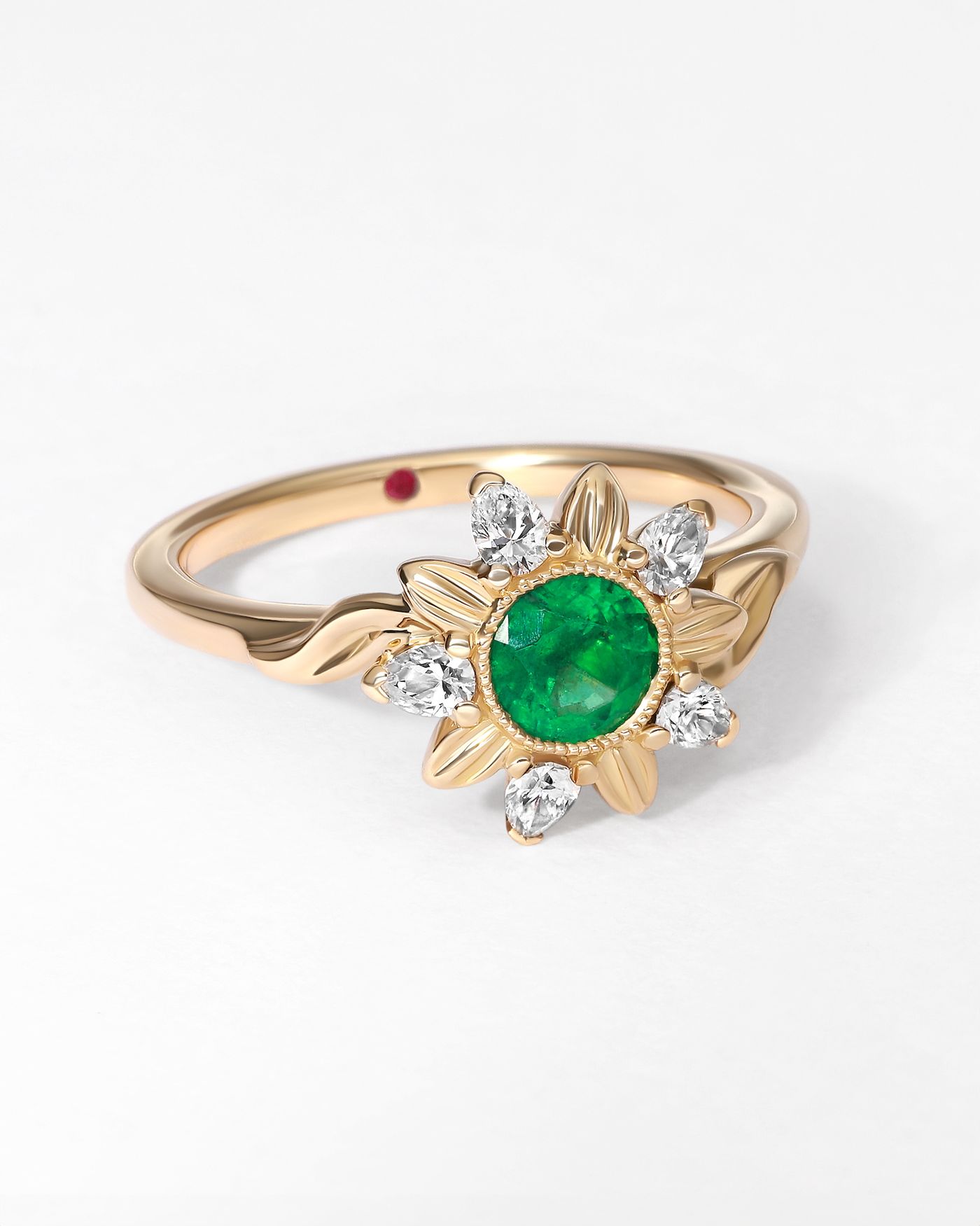 Bespoke floral organic engagement ring with round emerald and engraved yellow gold petals