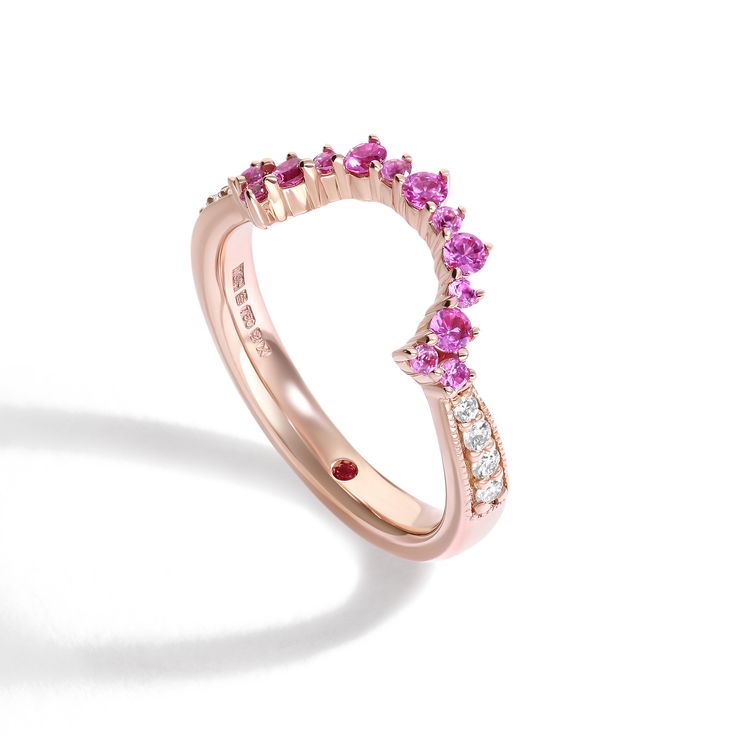 Curved pink sapphire and diamond pave rose gold wedding band ring