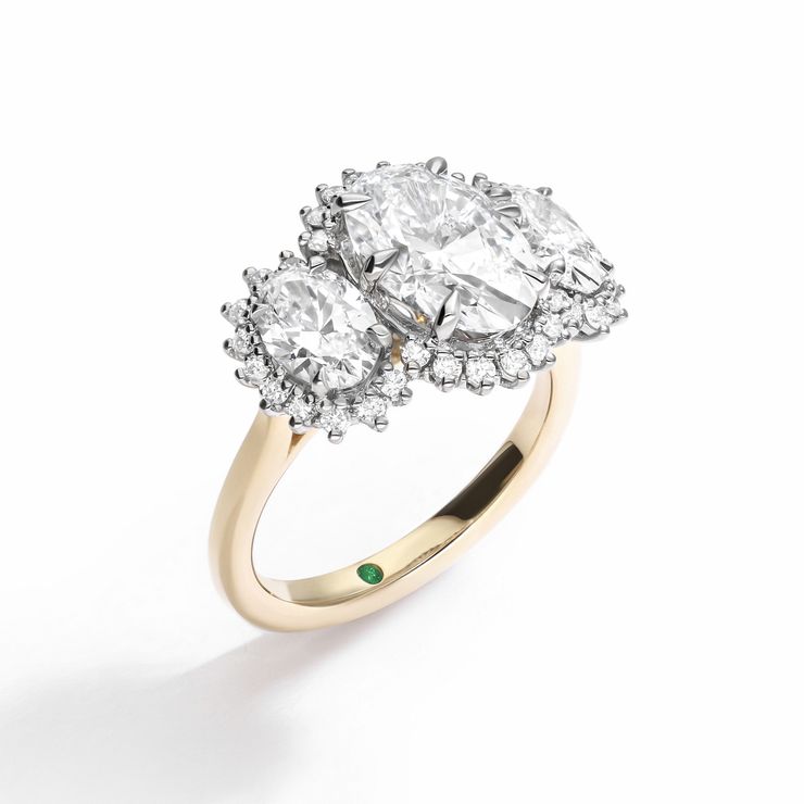Mixed metal yellow and platinum oval diamond halo trilogy engagement ring