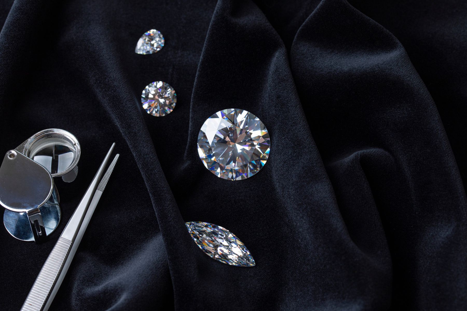 Loose diamonds with jeweler’s tools