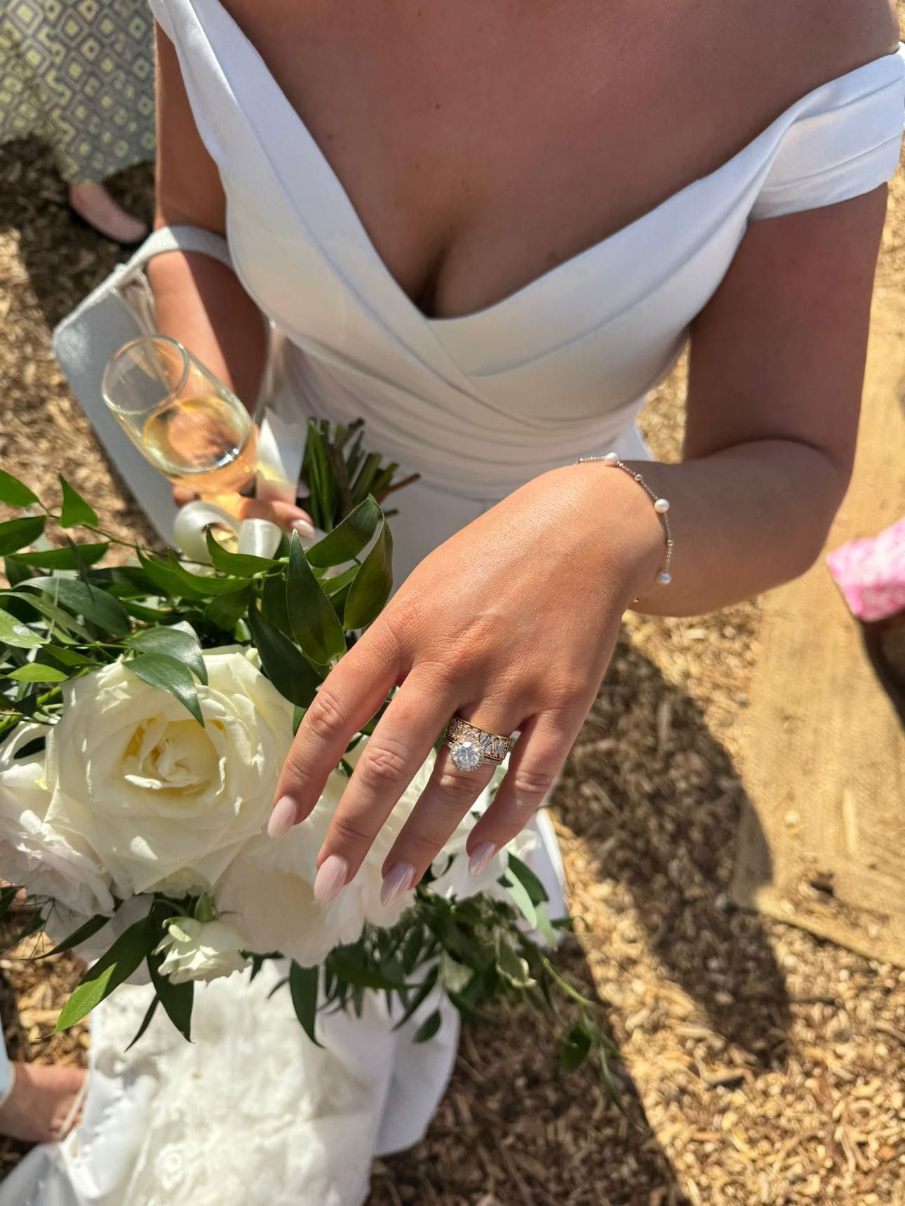 Bride showcasing engagement ring and bouquet