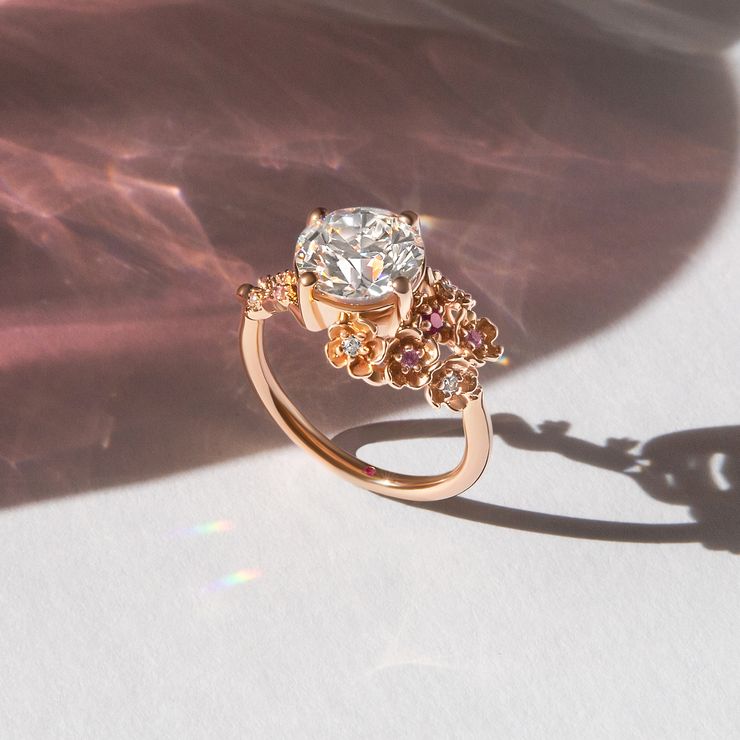 Lunarose organic engagement ring feature ombré pink sapphires set in blossom petals