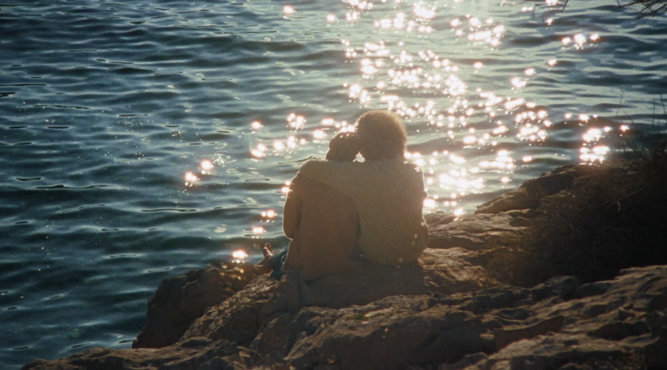 Couple watching sunset after engagement moment