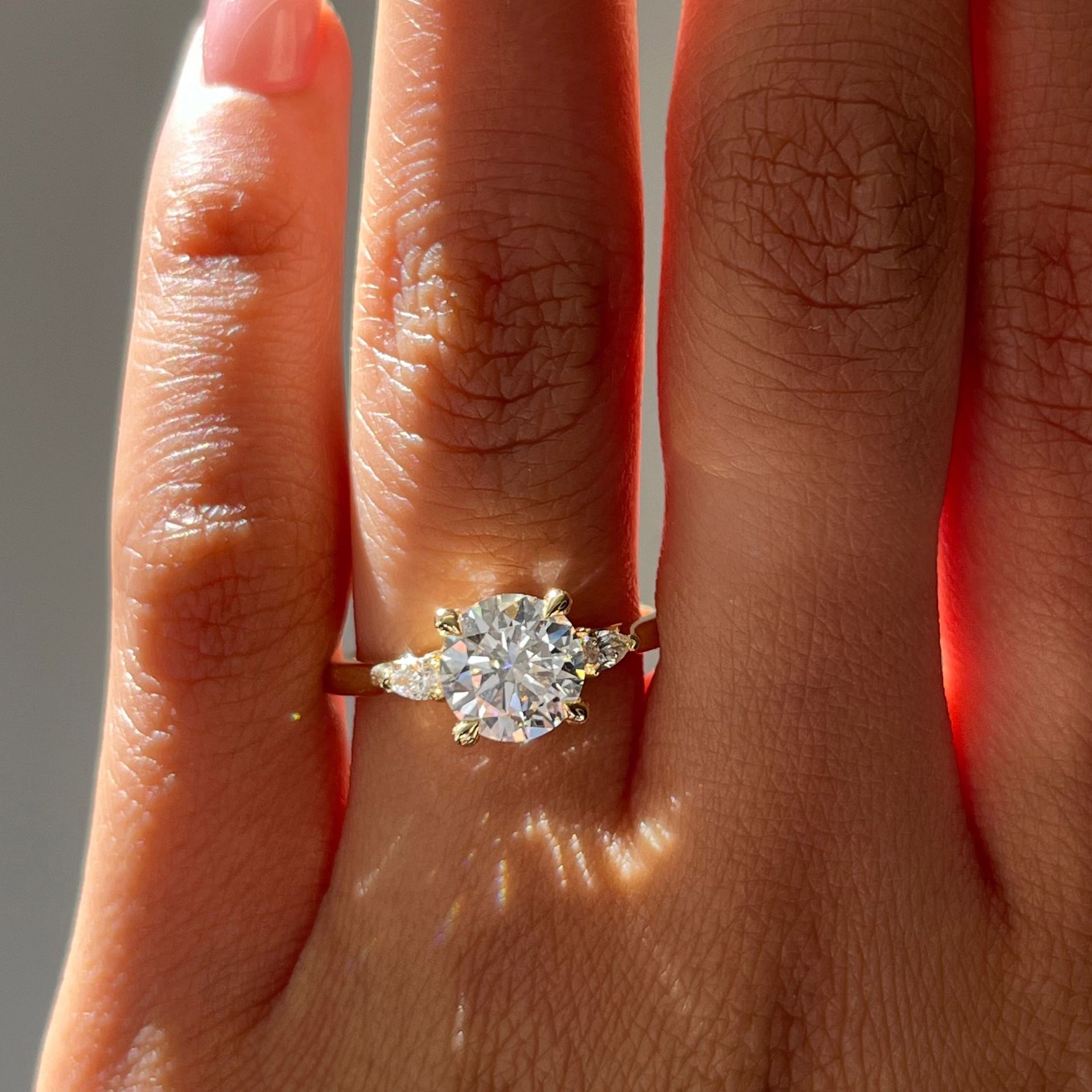 I want a round brilliant diamond in yellow gold, classic on the finger and magical in the light.