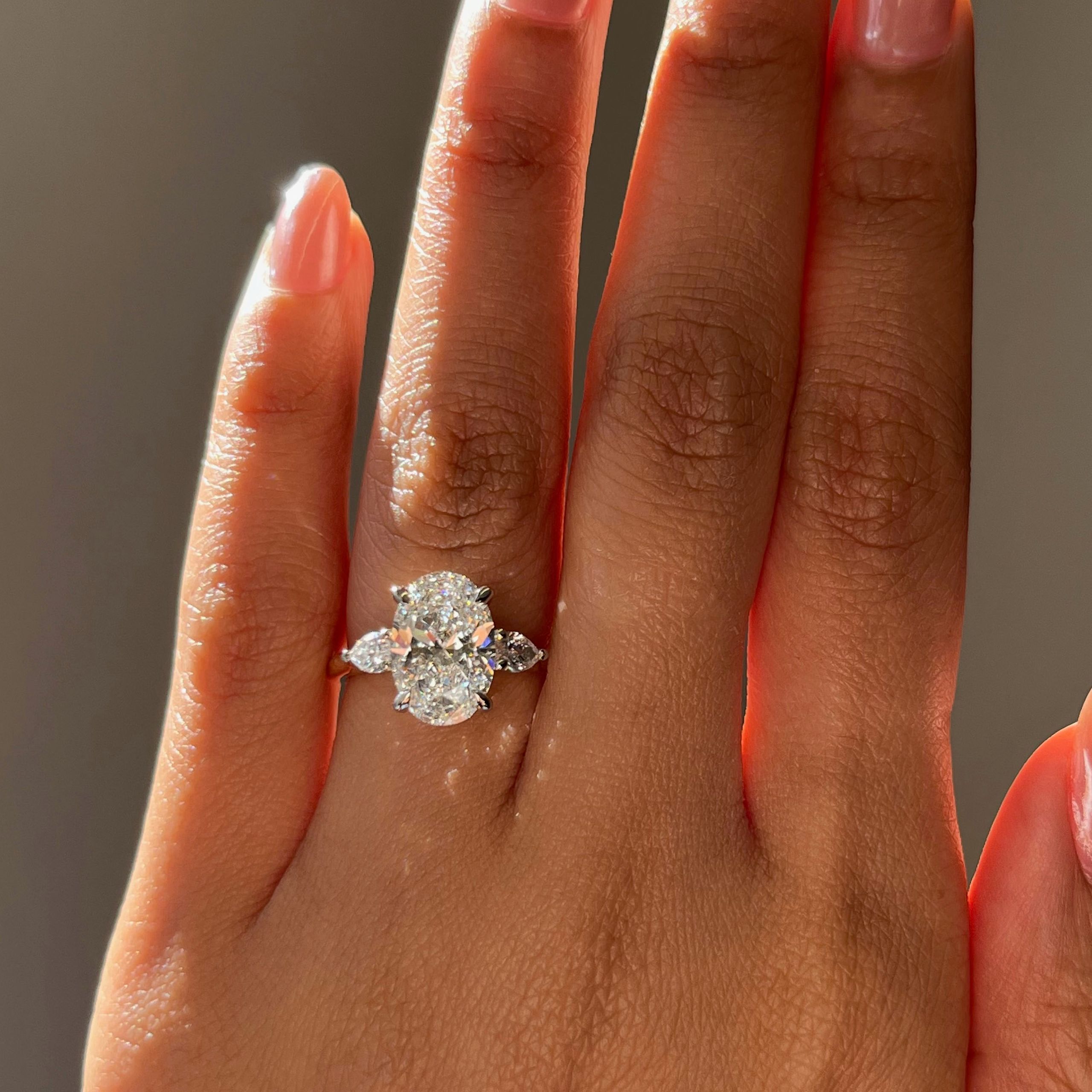 I want a showstopping oval centre, pear side stones that add to the sparkle, and a ring that catches the light from every angle.