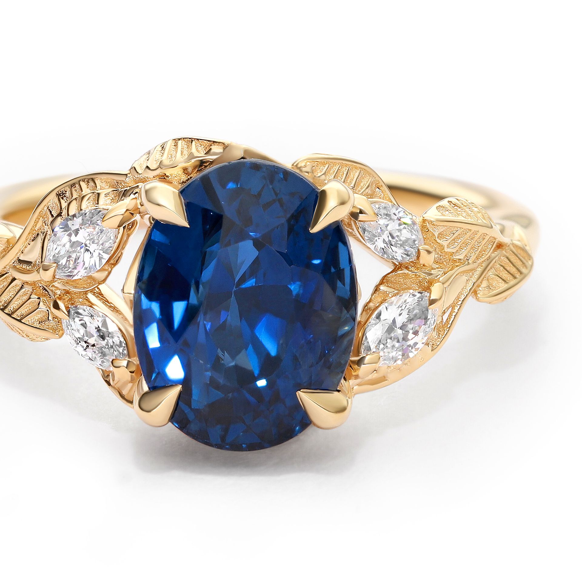 I want a deep blue sapphire, along with a nature motif.