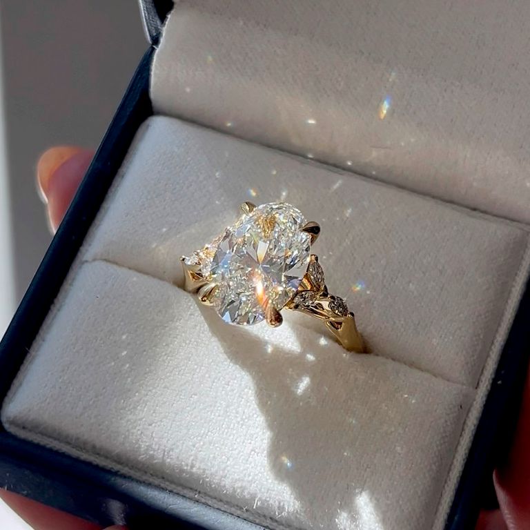 I want an oval in yellow gold that scatters light like magic, with something special that sets it apart.