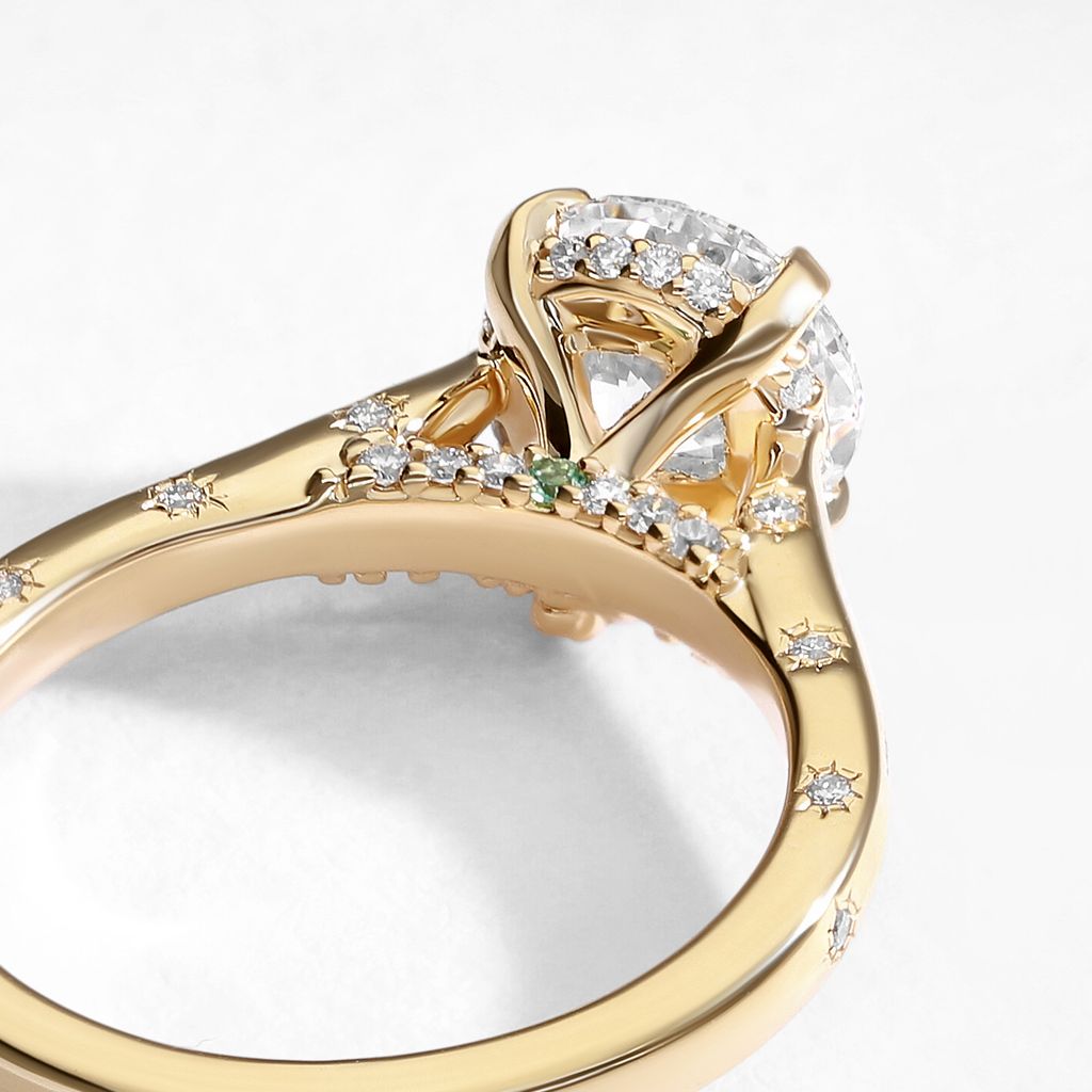 I want to add personal touches that elevate a classic silhouette, with diamonds from the halo to the band and a hidden green stone that only we know is there.